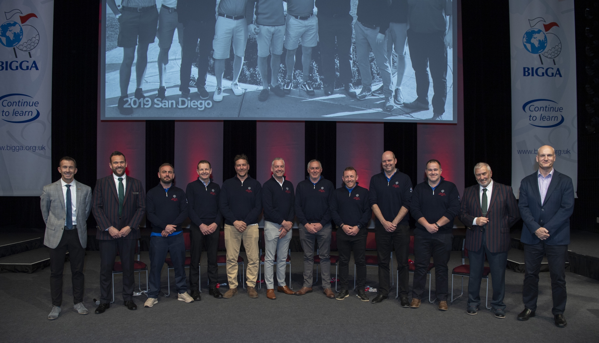 Eight of the 2022 delegates gathered at BTME alongside (far left) the GCSAA's Rhett Evans and Bernhard and Company's Steven Nixon and (far right) Stephen Bernhard and BIGGA's Jim Croxton